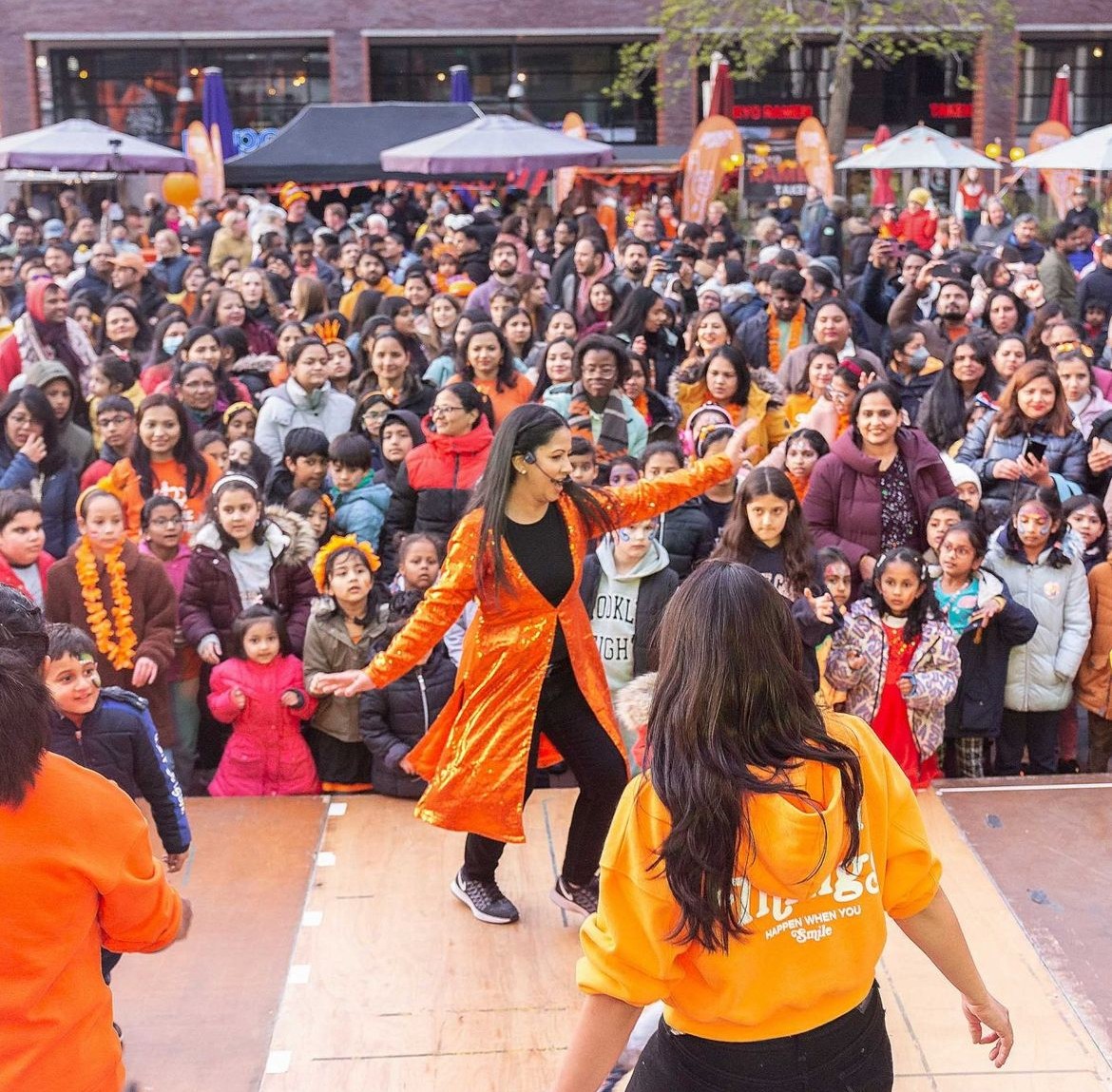 Bolly Beat Busters — colourful dancers jumping in celebration